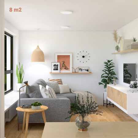 Küçük Oda Dekorasyonu Püf Noktaları. Küçük oda dekorasyonu için kullanılan görselde, içerisinde küçük bir koltuk, saksı bitki ve ahşap sehpa olan, beyaz duvarlı minimalist bir oturma odası var.